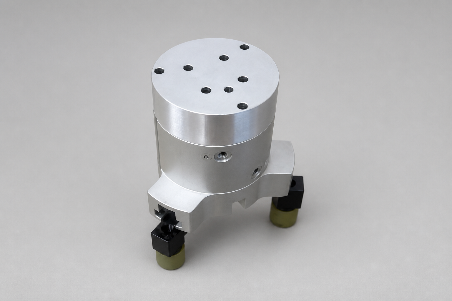Cylindrical machined fixture with a drilled top plate and mounted base components